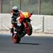 2024 Yamaha XSR900 GP popping a wheelie on track straight