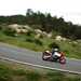 2024 Yamaha XSR900 GP shot from a high vantage point of the bike and rider leaning into a bend