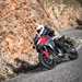 2025-on Ducati Multistrada V4S leaning into a mountain corner